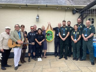 Ambulance, pub staff and musicians outside The Three Bishops