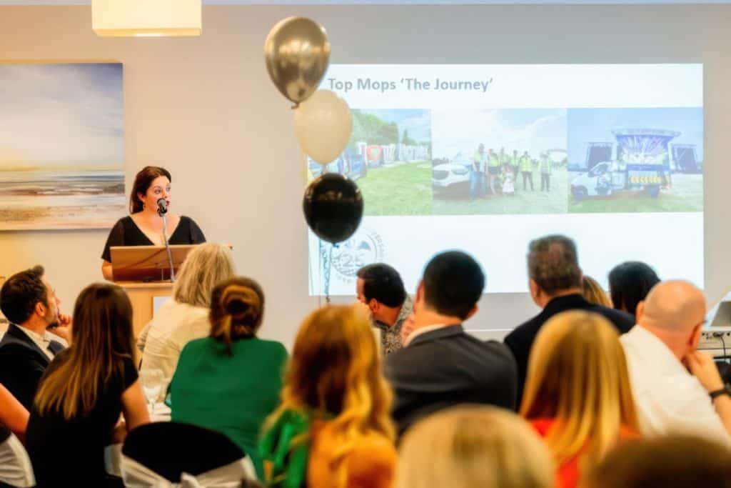 Sarah Ford, the Relationship Manager of Top Mops presenting at 25th anniversary event