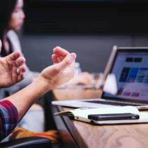 people using laptops at meeting table