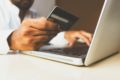 person paying by credit card through website on laptop