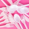 plastic cutlery on pink background