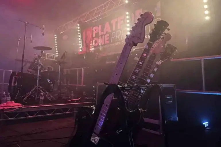 Platform one stage with drums and guitar