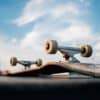 upside down skateboard on ramp with blue sky in background