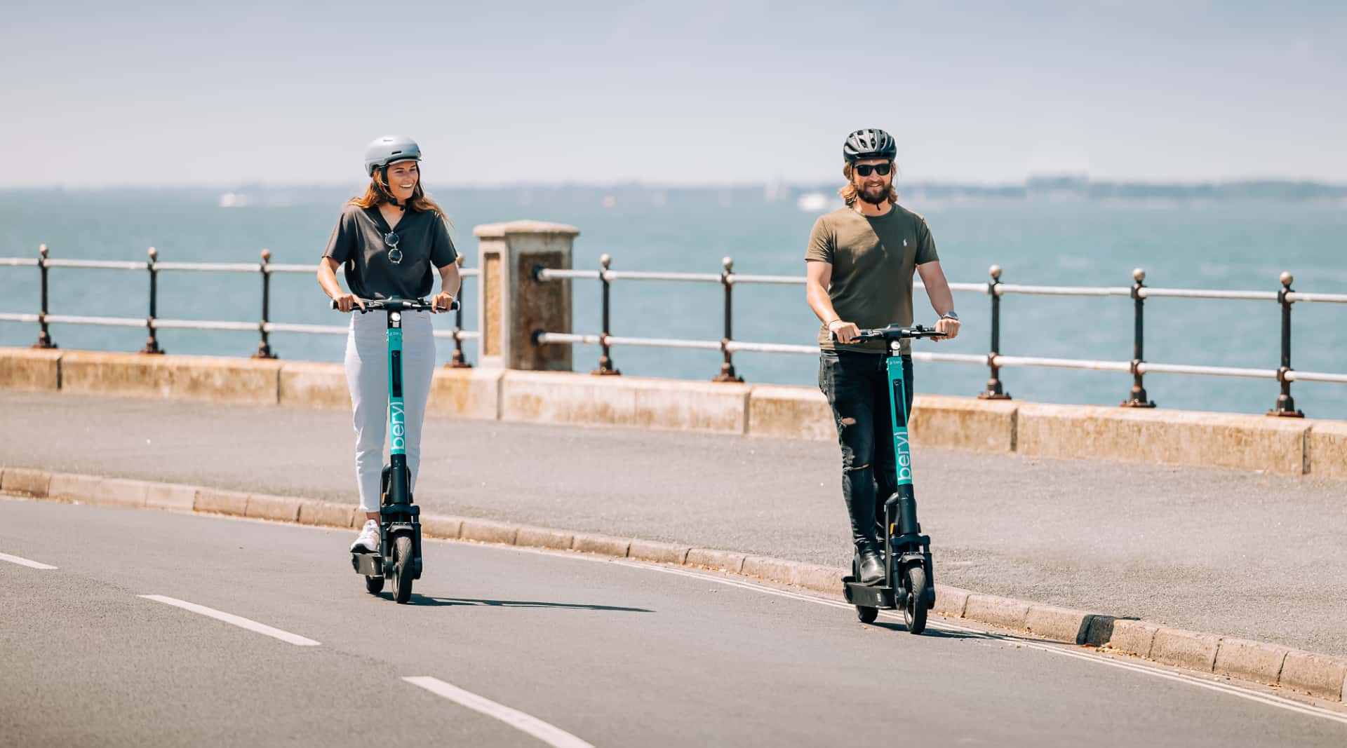 People on e-scooters along Cowes-Gurnard esplanade