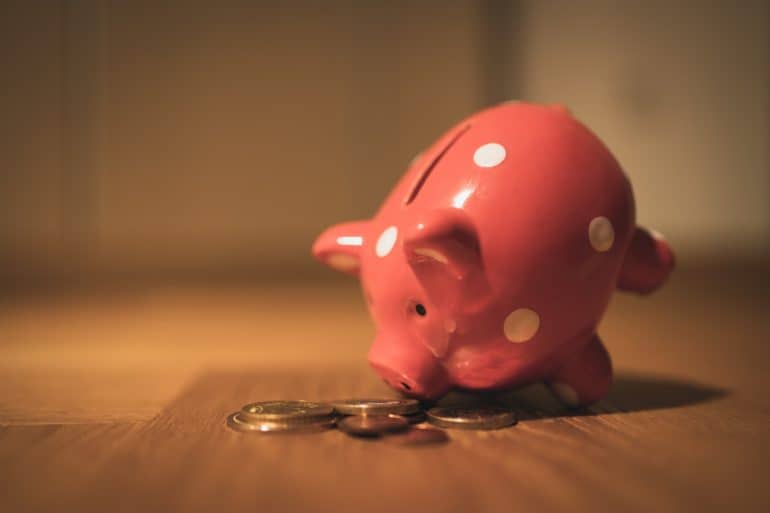 Pink elephant piggy bank with coins emptied out of it