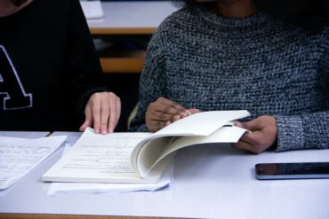 Teens studying a book