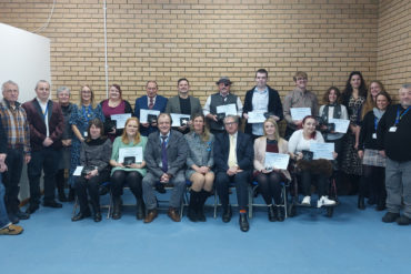 adult learners with their certificates