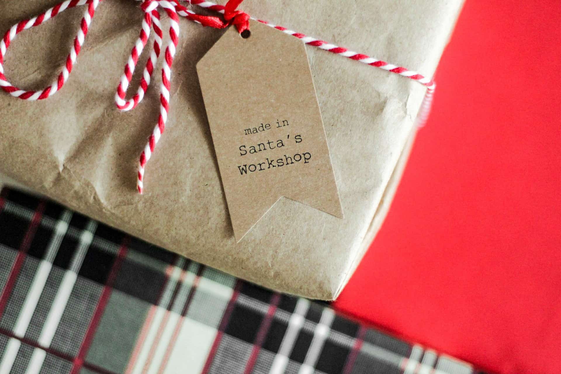 christmas present wrapped in brown paper with tag saying made in santas workshop