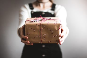 woman holding out a christmas parcel