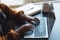 woman typing on laptop keyboard