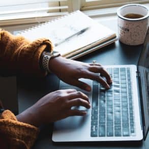 woman typing on laptop keyboard