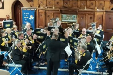 Abbey Brass playing in a church by Simon Smith