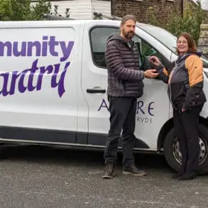 Laura Hales handing over keys to new mobile community pantry to Steve Johnson, director of community and partnership at Aspire