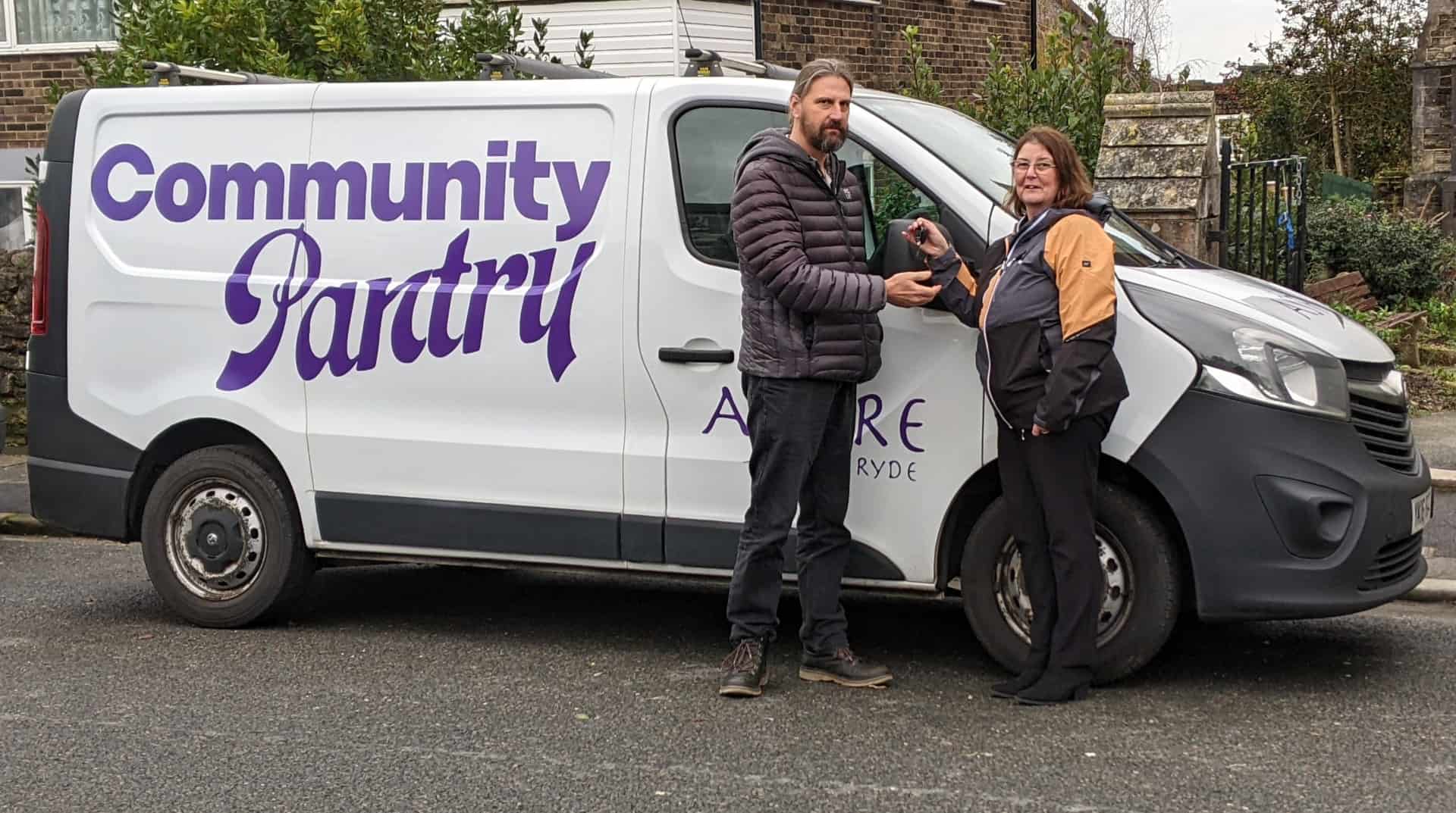 Laura Hales handing over keys to new mobile community pantry to Steve Johnson, director of community and partnership at Aspire