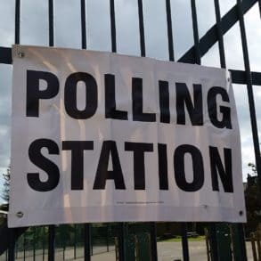 Polling station sign on railings