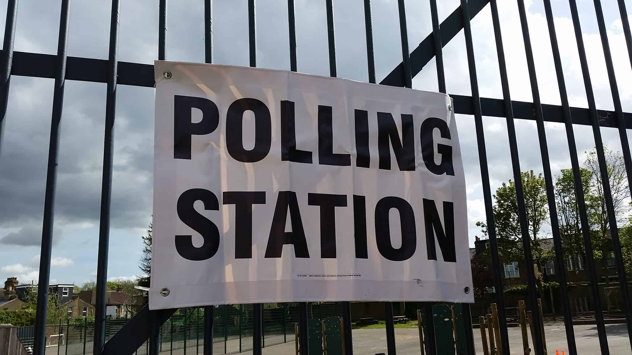 Polling station sign on railings