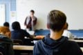 View from back of classroom of teacher at front