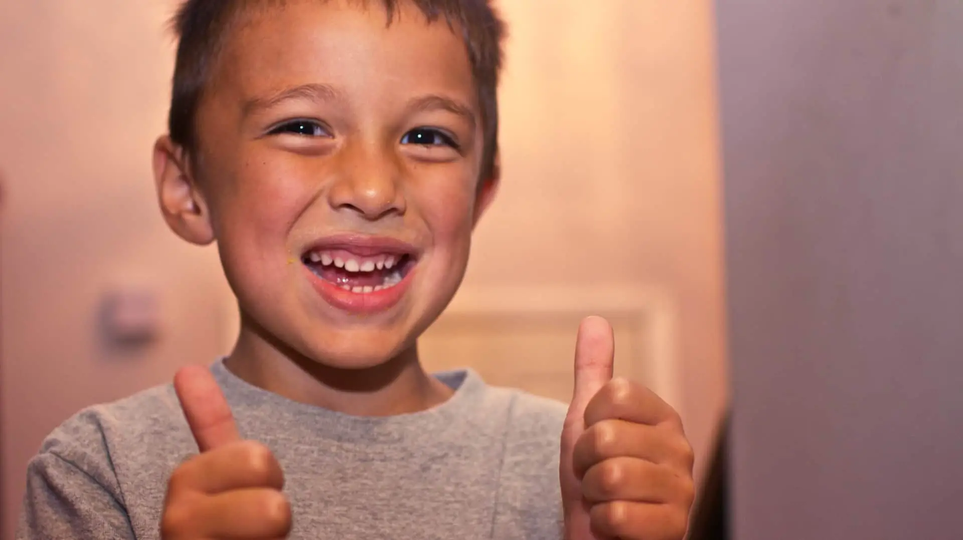 young boy with thumbs up