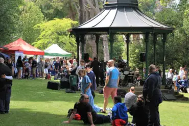 The Bandstand in Ventnor Park with lots of people milling around for Ventnor-Day