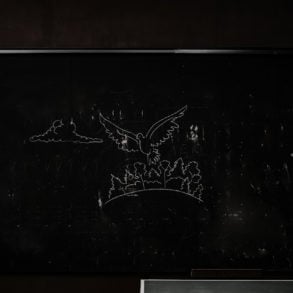 Blackboard with peace dove chalked on it