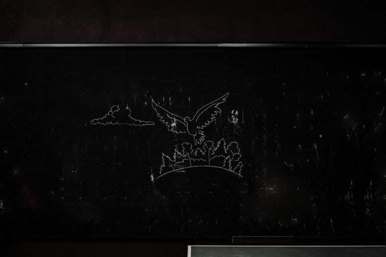 Blackboard with peace dove chalked on it