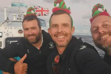 Paul Berry, Chris Mannion and Xavier Baker on the boat with Christmas hats