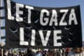 People at rally holding a 'Let Gaza Live' banner