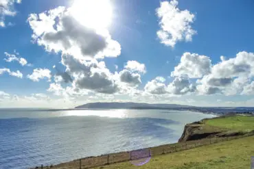 Looking down to Sandown Bay from Culver Cliff - blue sky in background