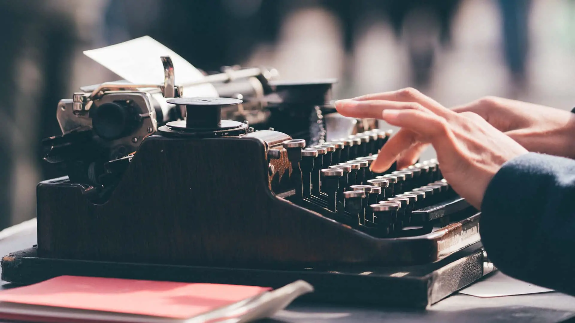 person typing on a vintage typewriter