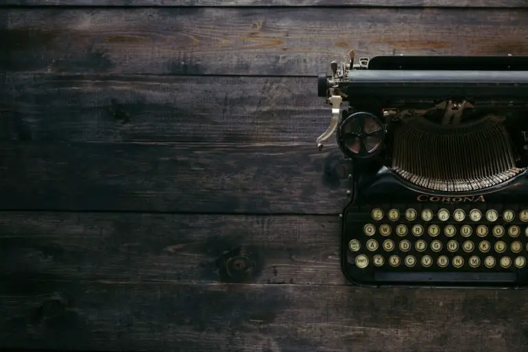 Black corona typewriter on dark wooden desk top