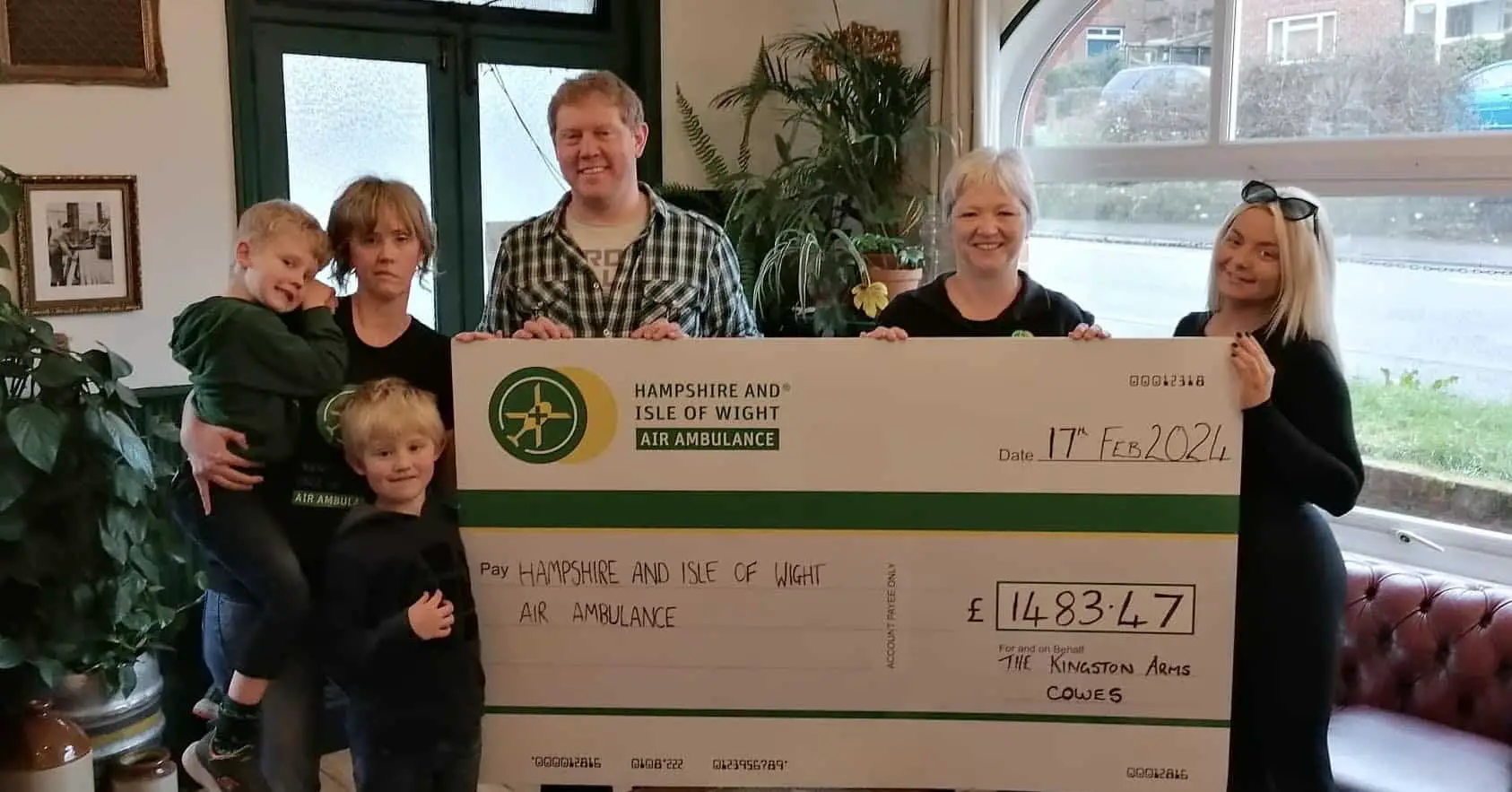 Chris and Gilly with the kids and their giant cheque being presented to Air Ambulance representatives
