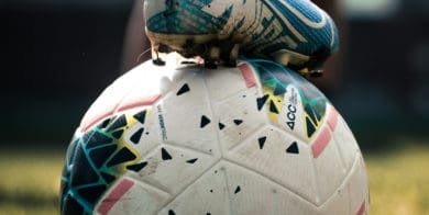 Football player's foot on ball