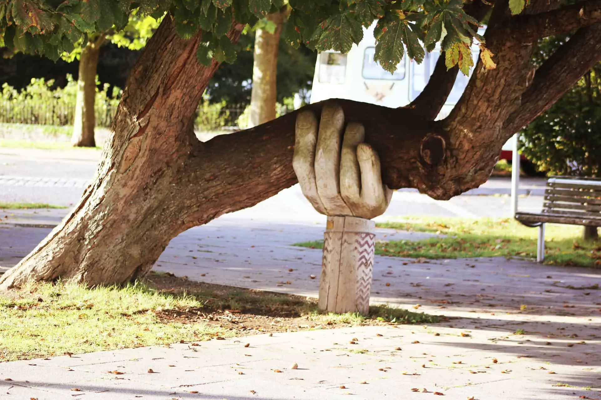 Giant carved hand holding up a large tree branch