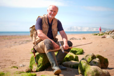 Martin Simpson on the beach with fossil hammer