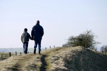 Man and son walking in the countryside