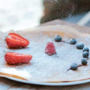 Pancake covered in fruit and sugar
