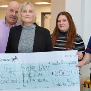 Val and her family presenting a giant Cheque to the Stroke Unit