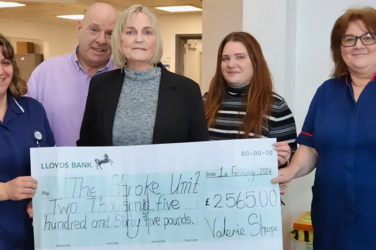 Val and her family presenting a giant Cheque to the Stroke Unit