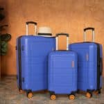 Three blue suitcases and hat by american green travel
