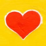 red heart painted on yellow wall