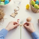 Child decorating easter eggs by jeshoots-com