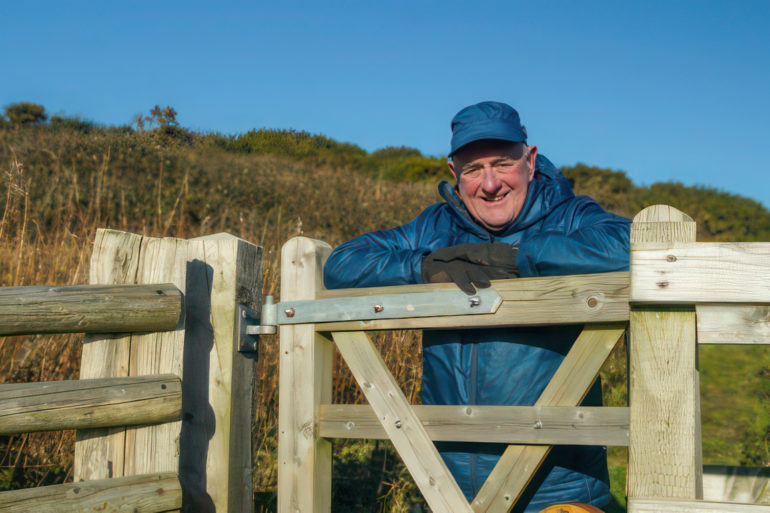 David Howarth standing by a country gate