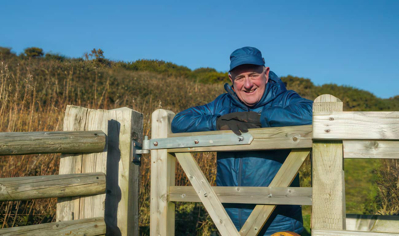 David Howarth standing by a country gate