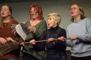 Four female actors on stage performing Lillies of the Land