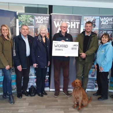 The latest charities to benefit from WightAID grants are, from left,: Sandown Aviation Men’s Sheds, White Horse CIC, Sandown and Historical Association, Terry Shaw, cheque holder representative from the Unite union, who are WightAID donors/supporters; The Arukah Project CIC.Mavis the WightAID dog is pictured front