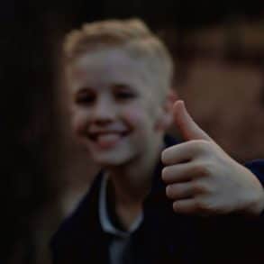 Young boy giving a thumbs up by mark fuller