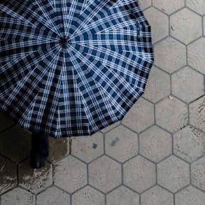 aerial view of umbrella against wet paving stones