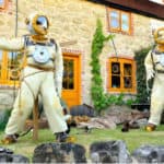 scarecrows dressed up in vintage diving suits