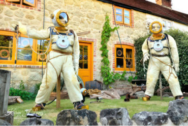 scarecrows dressed up in vintage diving suits