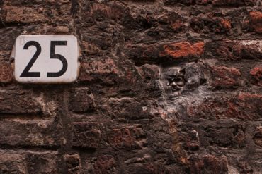 house number plate for 25 on brick wall
